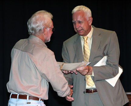 Gary Moreland (left) receives a certificate and prize money from Dr 